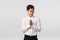 Mysterious and devious young good-looking asian businessman in white shirt, pants, rub hands and squinting sly, have