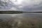 Mysterious dusk over a lake. Weather change - spring in Masurian Lake District. Poland.