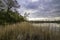 Mysterious dusk over a lake. Weather change - spring in Masurian Lake District. Poland.