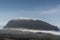 Mysterious Foggy Island WIth Buildings and Misty Clouds