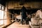 A mysterious hooded figure from behind, looking down on disused equipment in an abandoned industrial building