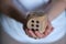 Mysterious lady grasps an oversized gaming dice, ready for action. Exploring the growing trend of board game cafes and