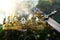 mysterious and magical photo of silver king crown and sword over the stone covered with moss in the England woods or field