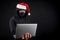 Mysterious male santa hacker holding laptop computer