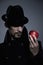 Mysterious man holding an apple