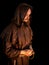 Mysterious monk on dark background.