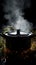 Mysterious simmer Steam rises from a pot in a dark logo