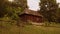 Mysterious spooky wooden cabin in a forest.