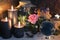 Mysterious still life with blak candles, crystal ball and rose on witch table