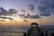 Mysterious sunrise in Mexico. A wooden walkway goes over the water to the canopy.