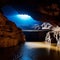 mysterious underground cave with glowing crystals and underground river