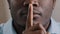 Mysterious unknown male face part african american adult man put finger to lips ask be quiet make gesture silence show