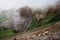 Mysterious waterfall in fog in mountains