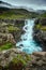 A mysterious waterfall hiding in a valley in Iceland. In the summer