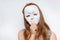 Mysterious woman cover her face behind anonymous mask