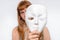 Mysterious woman cover her face behind anonymous mask