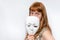 Mysterious woman cover her face behind anonymous mask