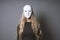 Mysterious woman hiding face and identity behind mask