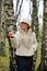 The mysterious woman keeps decorative apple on a palm in a hat