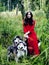 Mysterious woman in red dress with tree wolfs, forest, husky dogs mystery portrait, lifestyle people outside