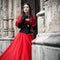 Mysterious woman in red Victorian dress