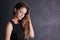 Mysteriously attractive. Studio shot of a seductive young woman posing against a dark background.