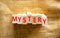 Mystery symbol. The concept word Mystery on wooden blocks. Beautiful canvas background, copy space. Business and mystery
