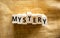 Mystery symbol. The concept word Mystery on wooden blocks. Beautiful canvas background, copy space. Business and mystery