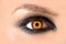 Mystic amber eye, witch witchcraft concept, fairy-tale look, fairy or young woman with beautiful make-up and yellow