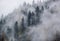 Mystic cloudy and foggy autumn alpine mountain slopes scene. Austrian Lienzer Dolomiten Alps