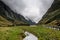 Mystic heavy clouds in green rocky Norway valley