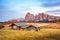 Mystic  magical fantastic autumn landscape with wooden houses in the backgroundin Alpe di Siusi in the Dolomites Alps at sunset.