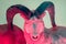 Mystical beast. Pan devil creature. Dall sheep over red light