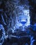 Mystical blue goblet illuminated in a rocky cave