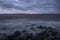 Mystical foggy sea and rocky shore in the evening