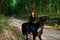 Mystical girl in wreath wear in black at horse