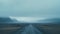 Mystical Icelandic Landscape: Dark Aquamarine Road Amidst Foggy Mountains