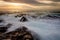 Mystical light over the ocean  with rocky ocean cascades