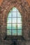 Mystical medieval church window with growing plants on the other side in Orval Abbey