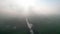 Mystical morning: aerial panoramic view of river, farm field, and forest landscape in morning fog and sunrise
