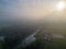 Mystical Morning: Aerial Panoramic View of River, Farm Field, and Forest Landscape in Morning Fog and Sunrise