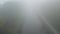 Mystical Morning: Fog-Enshrouded Road at Dawn