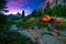 Mystical night landscape, in the foreground hike, campfire and tent