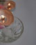 mystical still life. burning candles, a bowl of water and a rosary on a light background.