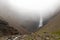 Mystical view of Hengifoss waterfall in a cloud, east Iceland. Summer hike