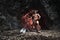 Mythological Minotaur  half bull half man stands in a rock cave in an aggressive stance