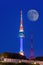 N Seoul Tower with full moon Located on Namsan Mountain in central Seoul,Korea.