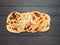 Naan flatbreads on dark wood, copy space, top view