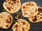 naan flatbreads on dark wood, copy space, top view