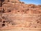 The Nabatean amphitheatre in the ancient city of Petra, Jordan. Theatre with row of seats and stairways carved into the side of